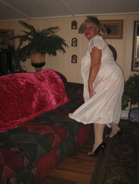 Obese granny takes off lace lingerie to model naked in OTK nylons