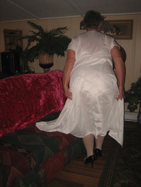 Obese granny takes off lace lingerie to model naked in OTK nylons