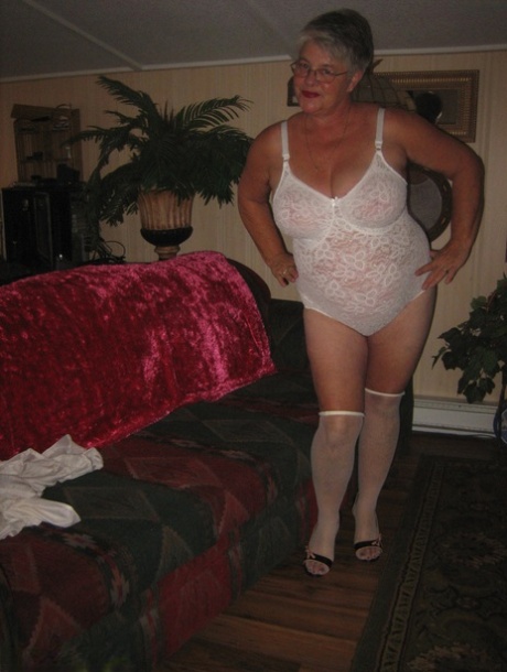 Obese granny takes off lace lingerie to model naked in OTK nylons