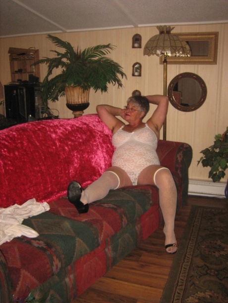 Obese granny takes off lace lingerie to model naked in OTK nylons