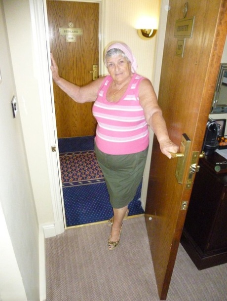 Obese grandmother licks her own nipples as she strips naked in living room