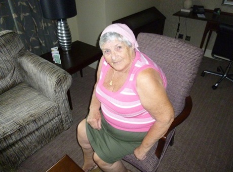 Obese grandmother licks her own nipples as she strips naked in living room