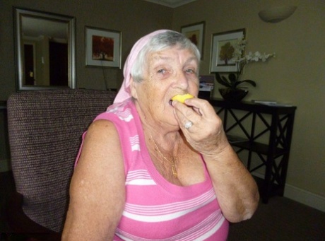 Obese grandmother licks her own nipples as she strips naked in living room