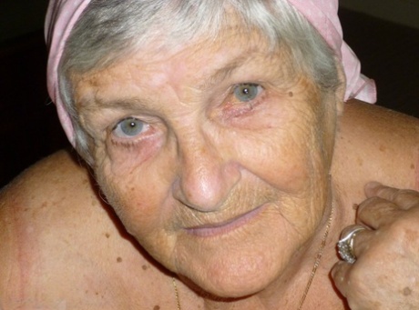 Obese grandmother licks her own nipples as she strips naked in living room