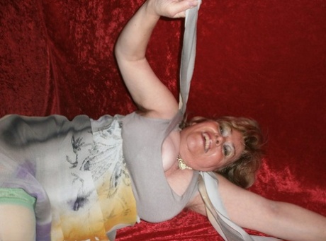 Chubby mature granny Caro in green stockings flashes lace panty cameltoe