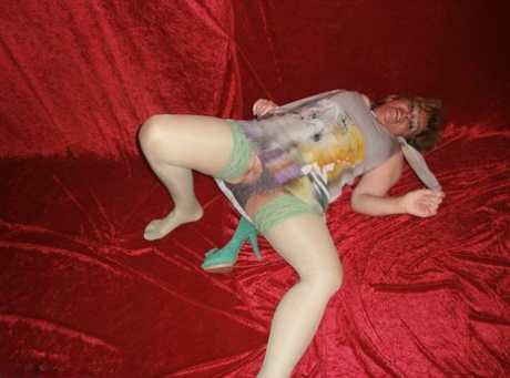 Chubby mature granny Caro in green stockings flashes lace panty cameltoe