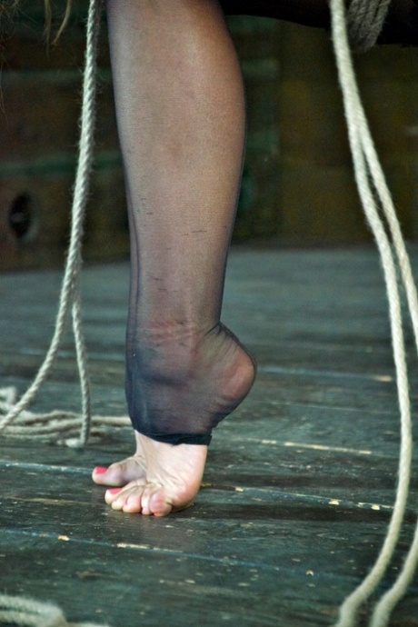Busty slave hung on cross and tortured with tongue clip & other harsh devices