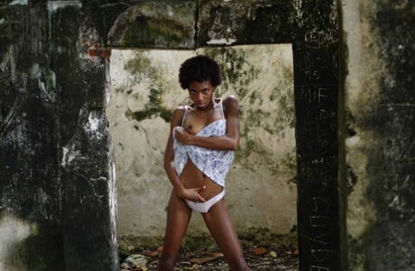 Long legged ebony girl Jess exposes her tits and bush in an abandoned building