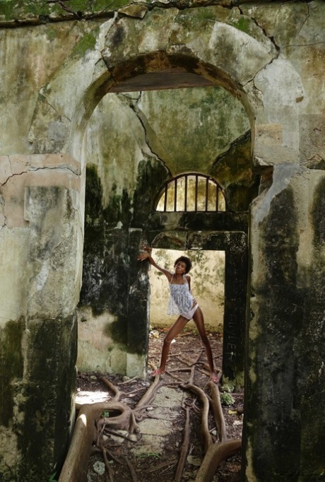 Long legged ebony girl Jess exposes her tits and bush in an abandoned building