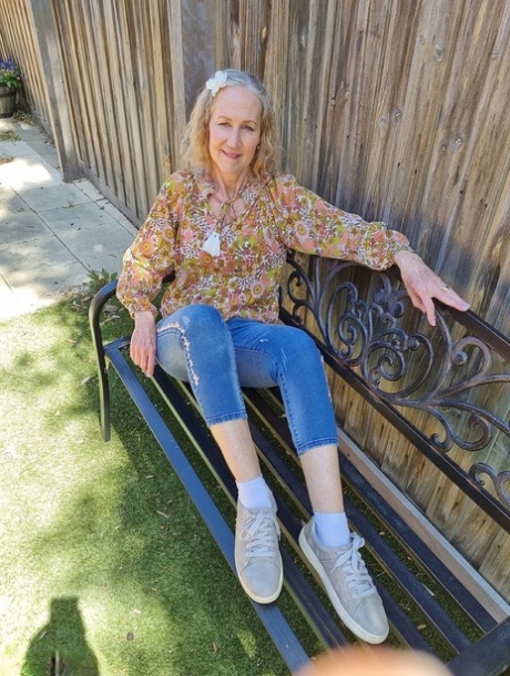 Old blonde woman Jacqueline goes nude on a blanket in socks and running shoes