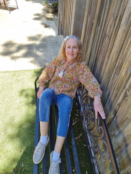 Old blonde woman Jacqueline goes nude on a blanket in socks and running shoes