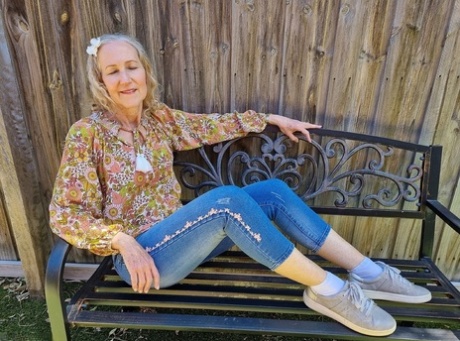 Old blonde woman Jacqueline goes nude on a blanket in socks and running shoes