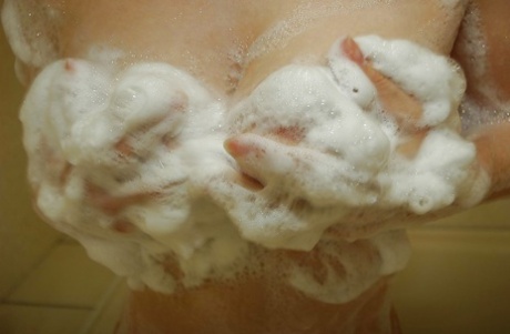 Sassy asian mature lady with unshaven pussy and nice tits taking shower