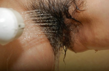 Sassy asian mature lady with unshaven pussy and nice tits taking shower