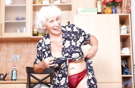 Fat granny uncovering huge tits from nice underwear and playing with a big dildo
