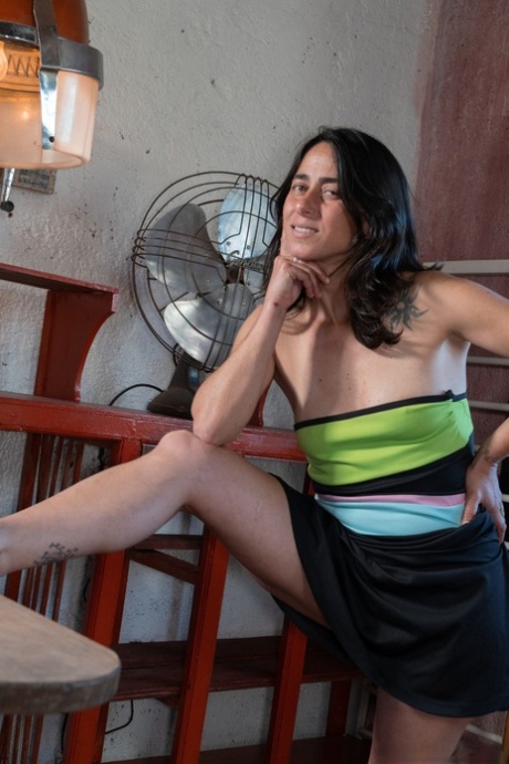 Mature brunette Soledad undresses to show her hairy pussy & her small tits
