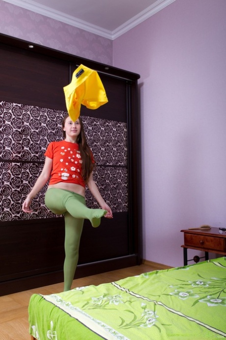 Teen Flora gets rid of her yellow skirt and stockings and shows bushy beaver