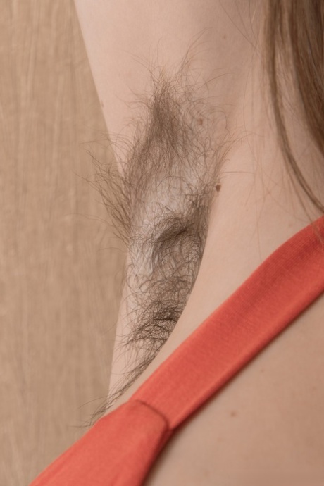 Tall hottie Donatella fingers her hairy beaver as she strips pantyhose off