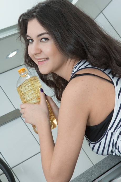 Young vixen Pavla puts vegetable oil on her body and spreads her hairy snatch