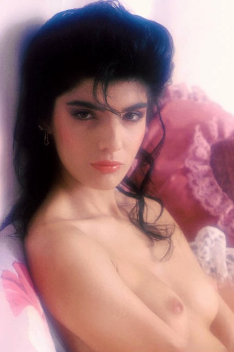 Sultry retro model with big hair & small tits showing off her hairy beaver