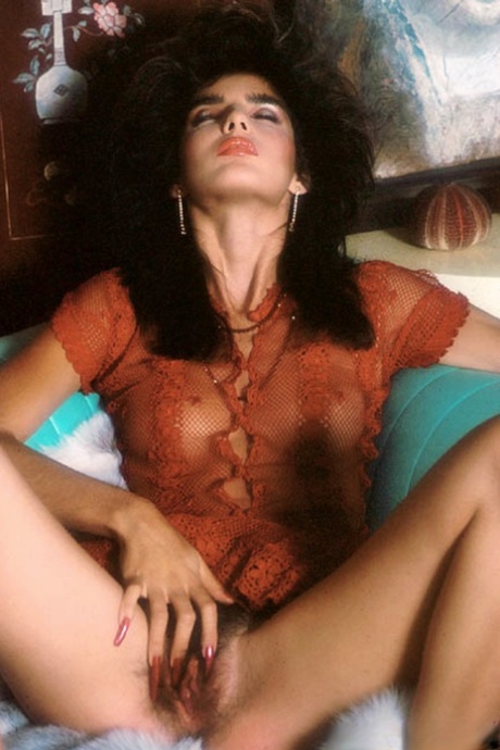 Sultry retro model with big hair & small tits showing off her hairy beaver