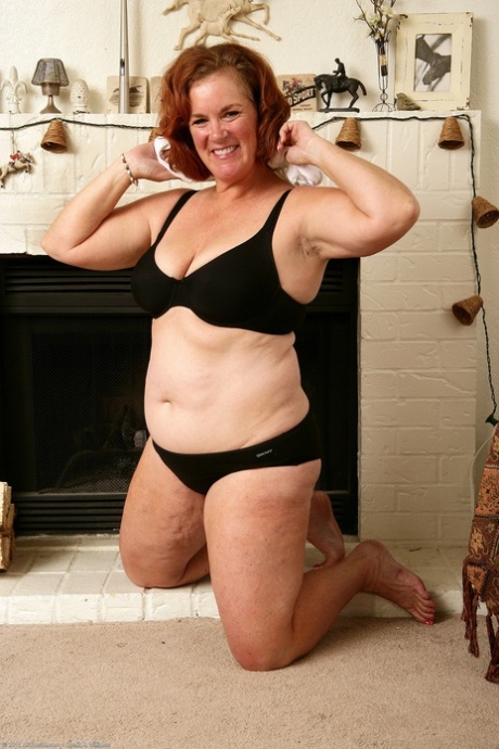 Chubby mature Lucy A exposes her big tits and hairy pussy in a solo