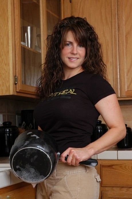 Petite babe Tori reveals her amazing big breasts and poses in the kitchen