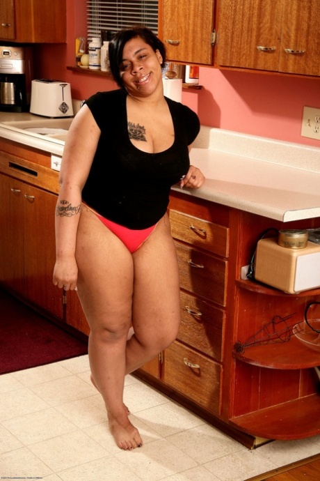 Hairy ebony Nykole shows off her big tits & her great ass in the kitchen