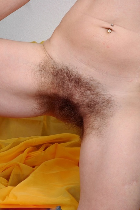 Redheaded housewife Angelika unveils her unshaved armpits & super hairy crotch