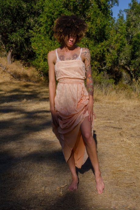 Exotic ebony Kendi Oh unveils her hairy tattooed body in nature