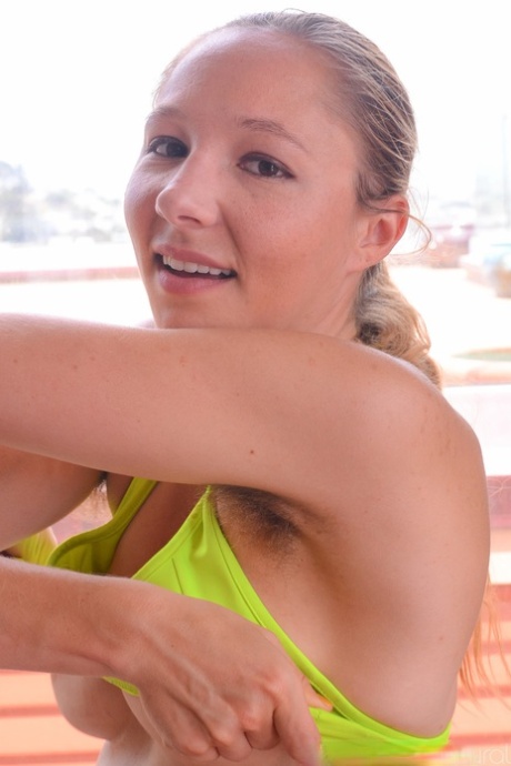 Brunette vixen Maggie Mayhem reveals her big tits and hairy body as she strips