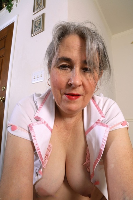 Naughty granny Olivia Olay undresses & shows her big booty & her hairy pussy