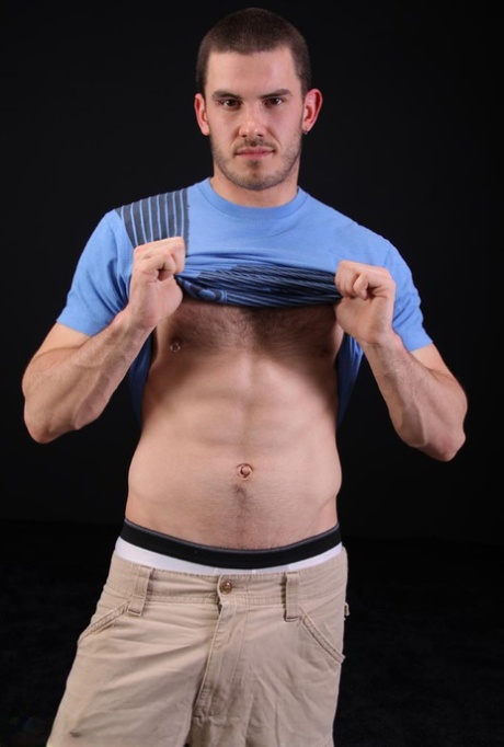Dark-haired gay model Vander unveils his big hairy dick as he strips
