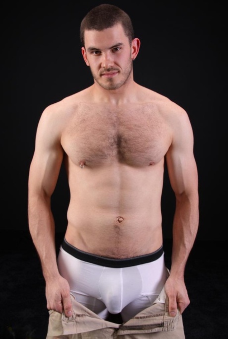 Dark-haired gay model Vander unveils his big hairy dick as he strips