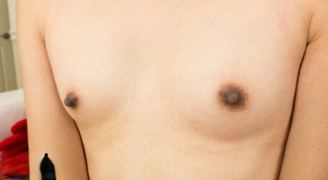 Gorgeous Asian tgirl Amy Sun exposes her small tits and hot dick in a solo