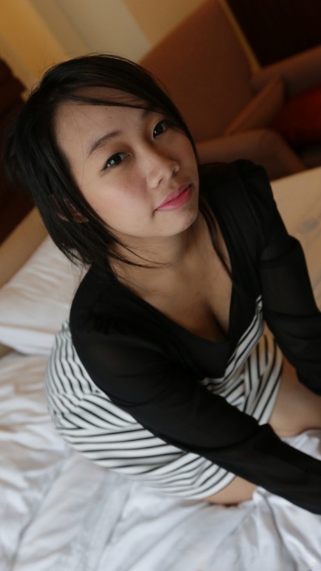 Amateur Asian babe Da B exposes her natural tits and takes a boner