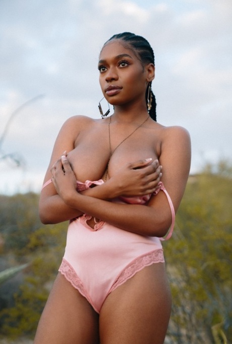 Beautiful ebony babe Nyla shows her juicy melons in a sexy outdoor striptease
