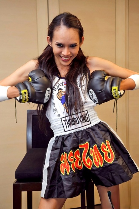 Young Thai boxer shows off her big shemale cock & small tits while training