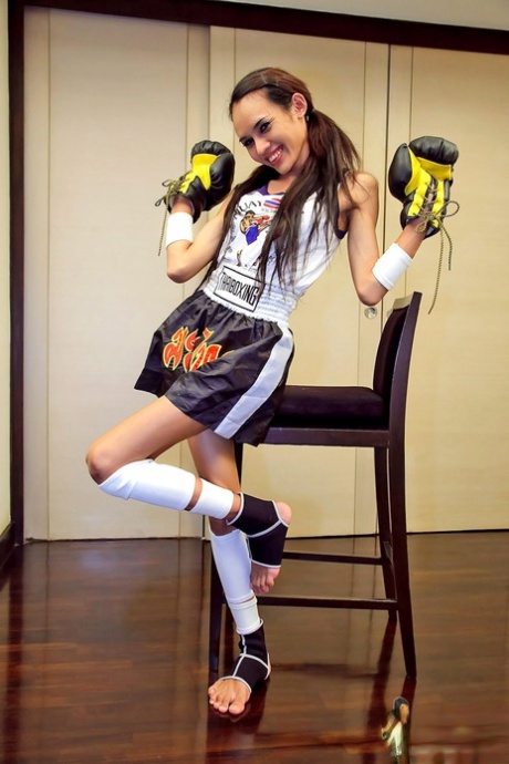Young Thai boxer shows off her big shemale cock & small tits while training