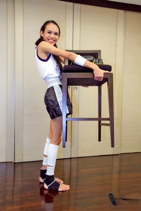 Young Thai boxer shows off her big shemale cock & small tits while training